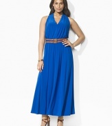 Crafted in sleek matte jersey, a flowing maxi dress is designed with a chic cutaway shoulder and belted waist for a figure-flattering look.