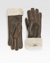 Classic cuffed style in supple leather with luxuriously warm shearling lining. Front logo tab detail About 11 long Dry clean by leather specialist Imported Fur origin: Spain