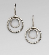 A circle of cabled sterling silver surrounds a sparkling pavé diamond-encrusted inner loop in these dangling earrings with a mobile-like design. Diamonds, 0.31 tcw Sterling silver Drop, about ¾ Ear wire Imported