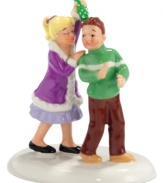 A little girl comes prepared to meet her crush, carrying a bouquet of mistletoe she bought in downtown Snow Village. She puckers up, but he's caught by surprise in this adorable figurine from Department 56.