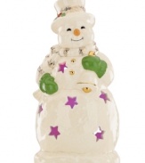A shining star, this porcelain snowman figurine from Lenox features pierced accents filled with the light from within. Gold accessories add to its whimsical glow.