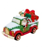 Santa treks in from the North Pole in his pickup, the only way to get oversize gifts under the tree! Handcrafted in pure glass with elaborate hand-painted detail, like a Radko license plate, sparkly gold rims and candy-stripe gift wrap.
