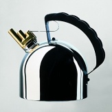 Kettle in stainless steel mirror polished with melodic whistle in brass and handle in black. Magnetic steel heat diffusing bottom.