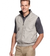 Look great on or off the golf course with this water resistant wind vest by Greg Norman for Tasso Elba.
