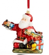 Santa takes great care to test-drive all the toys in his workshop, playing the role of conductor in this merrymaking ornament, handcrafted of Polonaise glass. By Kurt Adler.
