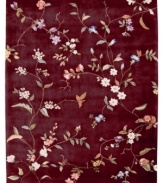 Crimson enchantress. The Julian Collection sets new standards of quality and clarity for hand-tuffed, hand-carved carpets. Bright salmon and ivory blooms on leafy vines set against a rich, ruby ground. Woven from luxurious 100% premium wool pile rivaling the finest hand-knotted rugs for texture and opulence. Luster-washed for added sheen.