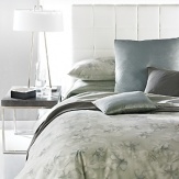 Watercolor blossoms are scattered across a pale shadow. Duvet has hidden button closure. Duvets and shams are self-reversing. Coordinates with the Flock Twill Sheeting in Spring or the Double Row Cord Percale Solid Sheets in Solar. Also coordinates with the Double Weave Blanket in Blade.