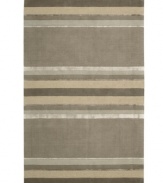 Linear designs are accented with exotic faux silk to create a timeless palette in the Sahara area rug from Calvin Klein. Crafted by skilled artisans in India, it features generously thick wool and viscose fibers woven to create remarkable strength and impeccable elegance.