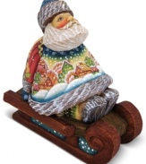 A beautiful work of art on its own, this ornament from DeBrehkt features an exquisitely carved Santa Claus sitting on a sleigh with a quaint, snowy village landscape hand painted upon his sweater.