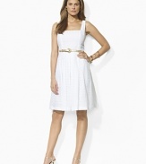 A chic square neckline and a full, flouncy skirt lend flirty charm to a breezy cotton eyelet dress, finished with a metallic faux-leather belt at the waist for an utterly feminine look.