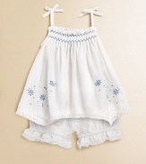 Sweet floral embroidery adorns a babydoll tunic, complete with a matching ruffle-trimmed bloomer for the perfect warm-weather set.Straight necklineSpaghetti straps with bowsPullover styleSmocked bodiceHandkerchief hemElastic waistbandCottonMachine washImported