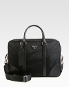 A simple, structured briefcase for all of your work-day essentials in tessuto nylon with saffiano leather trim.Zip closureDouble top handlesAdjustable shoulder strapInterior pocketID tagNylon16W x 11H x 5DMade in Italy