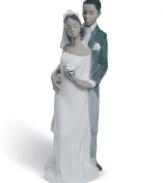 Bride and groom stand close in a loving embrace in this beautifully crafted figurine/cake topper from Lladró. Stands 8 tall.