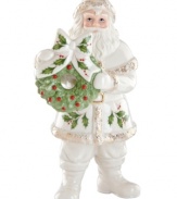 Santa's got it all. Radiating grace in glazed porcelain, this collectible figurine carries a simple wreath and, adorned with a quaint holly pattern, coordinates beautifully with classic Holiday decor by Lenox.