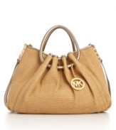 18K gold hardware and glossy leather ring handles add luxe appeal to this on-trend straw tote from MICHAEL Michael Kors.