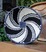 At once home decor, fruit bowl and conversation piece, the Oomva basket is hand woven in a cyclical pattern representative of life. Black- and indigo-dyed sisal and sweetgrass enrich any setting with stunning craftsmanship, color and texture.