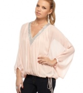 Glittery beads create a frosted trim on this gauzy, chiffon top from Baby Phat! Pair it with your favorite skinnies for a look that wears like a dream.