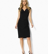 Fluid matte jersey drapes beautifully in a slinky, ruched silhouette featuring cap sleeves and a chic, crossover neckline.