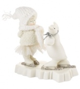 Crafted of pure porcelain bisque, this adorable Snowbaby is dressed for the weather as she dances and skates with a penguin friend in this timeless figurine from Department 56.