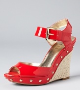 In slick and glossy coral red, GUESS's Tabari wedges boast alluring style.