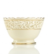 Distinguished by a scalloped edge, bands of gold and heart cutouts in creamy ivory porcelain, this lovely bowl combines traditional style and timeless grace. Qualifies for Rebate