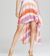 Enlivened by a colorful print, this GUESS skirt flaunts an elongated back hem for head-turning drama.