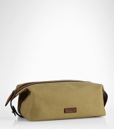 An impeccably stylish carrying case for the modern gentleman, this lightweight pouch provides sharp transport for essential toiletries in a leather-trimmed canvas construction.