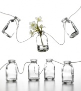 Garden garland. Mini glass bottles strung along a stainless steel wire offer a charming new way to spruce up backyard patios or casual kitchen decor. Personalize it with flowers, seashells or any number or colorful trinkets.