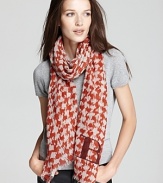 Burnt red and beige houndstooth and a BRIT logo decorate this sheer, wool scarf from Burberry.