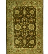 Traditional Turkish designs delight the eye in a winsome arabesque bordered motif, featuring vines, branches and blossoms flowing freely in rich green and brown tones. Pure wool is hand-tufted in a thick three-quarter-inch pile, finished with a cotton backing for long-lasting durability.