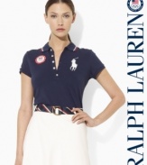 An iconic polo shirt from Ralph Lauren is crafted in a slim stretch silhouette from breathable cotton mesh and accented with bold country embroidery to celebrate Team USA's participation in the 2012 Olympic Games.
