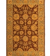 Bold colors, classic patterns. Featuring a traditional vine-and-blossom motif inspired by ancient Persian designs, this area rug from Safavieh adds a touch of drama and heirloom elegance any living space. Tufted in India from pure wool, it's sure to set just the right tone. (Clearance)