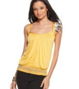 A removable feather pin adds tribal appeal to a tank top from Baby Phat that brightens your favorite jeans!