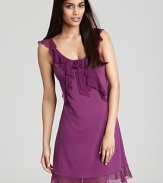 A sleeveless chemise with cascading ruffles along neckline and hem.