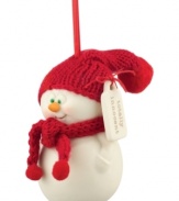 Big green eyes stare out with childlike wonder from this oh-so-innocent snowman ornament. A red knit scarf and hat contrast smooth porcelain bisque from Department 56.