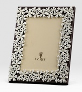 White Swarovski crystals shimmer on the platinum tone floral garland that surrounds this rich leather design.Holds 5 X 7 photoClassic beveled glassStretched leather backingGift boxedImported