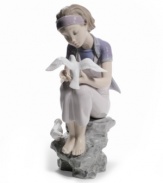 Experience tranquility. Perched on a rock embracing the simple joys in life, a graceful young lady studies the beauty and purity of visiting doves. A peaceful reminder to slow down and study the brilliant details in life, by Lladro.