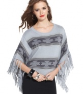 Material Girl's blanket-style poncho sweater adds an exotic touch to any outfit. The fringe trim gives it plenty of movement, too!