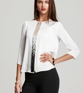 A study in modern design, a cascade of sequins emblazon a boxy VINCE CAMUTO blouse for an effortlessly edgy approach to the classic white shirt.