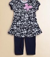 A floral ruffled tunic with pockets complements a matching pair of soft leggings.Envelope necklineShort cap sleevesPullover styleKangaroo pocketsSkirted hemElastic waistbandLogo embroideryTunic: 65% cotton/35% rayonLeggings: 94% cotton/6% spandexMachine washImportedAdditional InformationKid's Apparel Size Guide 