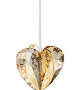 Goldtone metal pierced with intricate patterns and sparkling chatons adds even more splendor to this exquisite Swarovski crystal heart ornament.