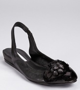 A ballet-inspired style is re-imagined in a slingback silhouette, dressed up with a satin flower detail on a dainty peep toe. From Vera Wang Lavender Label.