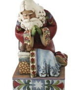 Santa kneels at the manger of little baby Jesus & glances adoringly down at the true reason for the season. Alive in deep hues and a mix of folk-inspired patterns, this figurine touches at the heart of Christmas.