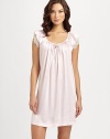 Liquid, silky-smooth fabric in a soft hue is accented with lady-like lace sleeves. Scoopneck with small keyhole and self-tie bowFront shirring for added drapeShort butterfly sleeves with semi-sheer lace layerAbout 36 from shoulder to hemPolyesterMachine washImported