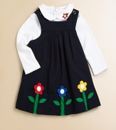 A beautiful, girly jumper/dress blooming with colorful floral appliqués and a pretty pleated bodice.SquareneckShoulder straps with button closureEmpire waistPleated bodice65% polyester/35% cottonMachine washImported Please note: Number of buttons may vary depending on size ordered. 