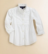 A traditional button-front design in timeless cotton poplin features pintucked detailing and ruffle trim for a girly look.Ruffled stand collarLong sleeves with single-button barrel cuffsButton-frontShirttail hemCottonMachine washImported Please note: Number of buttons may vary depending on size ordered. 