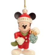 Mickey Mouse keeps a watchful eye for Minnie in this too-cute Christmas ornament featuring the iconic Disney character with a bouquet of mistletoe.