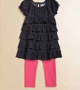 This charming two piece set for your little girl pairs a ruffled, denim tunic and boldly hued leggings with snap hem. Tunic ScoopneckShort sleeves with ruffled cuffsBack keyhole buttonRuffled hem Pants Elastic waistbandSnap hemTunic: 66% cotton/28% polyester/6% spandexLeggings: 57% cotton/38% polyester/5% spandexMachine washImported
