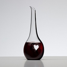 For over 250 years, Riedel Crystal's collections have become known for pushing the limits; offering ground-breaking ideas and award winning designs that enhance wine enjoyment. Bliss displays an off-center heart stamped from each side, compressing the crystal into a thin pane of solid glass. This innovative design provides a place for the fingers to rest as the wine flows out of the decanter into a waiting glass. Bliss is dressed up with a black tuxedo stripe that extends gracefully from top to bottom. For over 250 years, Riedel Crystal's collections have become known for pushing the limits; offering ground-breaking ideas and award winning designs that enhance wine enjoyment. Bliss displays an off-center heart stamped from each side, compressing the crystal into a thin pane of solid glass. This innovative design provides a place for the fingers to rest as the wine flows out of the decanter into a waiting glass. Bliss is dressed up with a black tuxedo stripe that extends gracefully from top to bottom.
