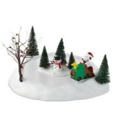 Snoopy and Woodstock clear the ice for a day of skating in this comical collectible from Peanuts Village, by Department 56. A well-lit tree sets a festive scene.